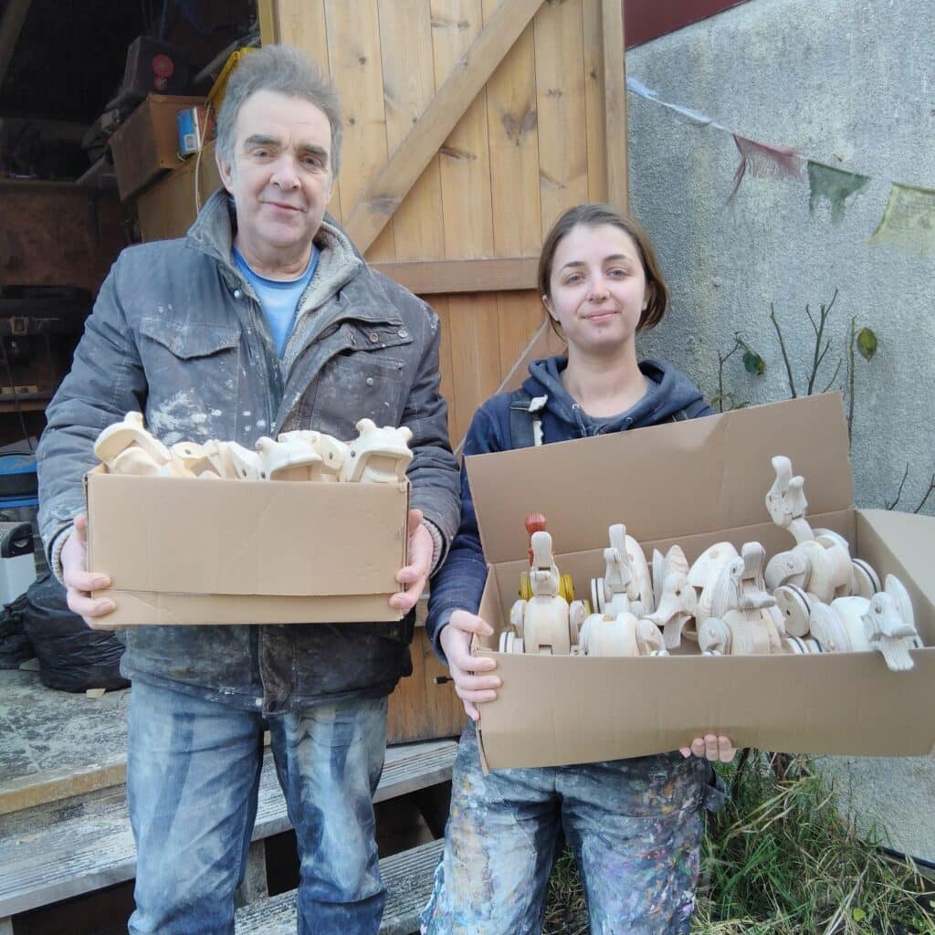 Father and daughter working on a big toy order